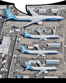 several boeing planes are parked in a row