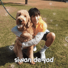 a man kneeling down holding a dog with the words siwan de yad written on the bottom