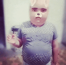 a little boy wearing a teddy bear mask is standing in front of a wall
