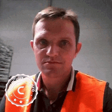 a man wearing an orange vest has a watermark that says copyright