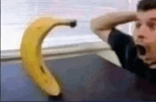 a blurry picture of a man holding a banana