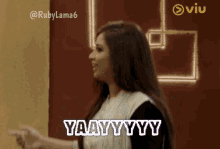 a woman with her arms in the air says yaay yy y