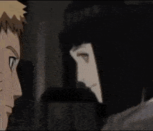 a man and a woman are standing next to each other and looking at each other .