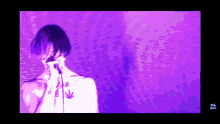 a man with a marijuana leaf tattoo on his chest sings into a microphone