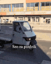 a small white van is parked in front of a building that says rossmann