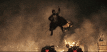 a man is flying through the air while riding a bull