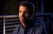 a man with a beard and a ring on his finger is talking to someone
