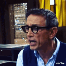 a man wearing glasses is making a funny face