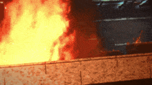 a large fire is burning in a dark room with the word fire visible