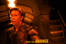 a picture of a man with the words " don 't be orange " on the bottom