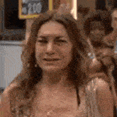 a woman is crying while standing in front of a sign that says 2.99 .