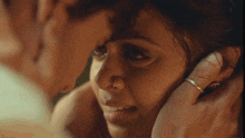 a man is touching a woman 's face with his finger .