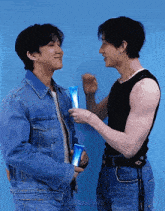 two men are standing next to each other and one is holding a bottle of lotion