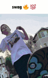 a boy wearing a t-shirt that says " all meridian " is standing next to a skateboard