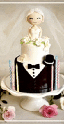 a wedding cake with a bride on top of it and a groom in a tuxedo .