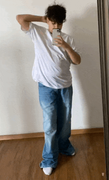 a person taking a picture of themselves in the mirror