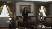 a woman is dancing in a living room with the words made in animotica below her