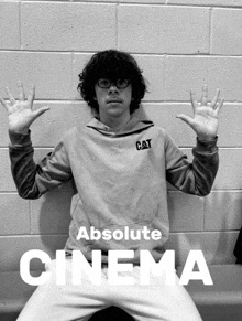 a poster for absolute cinema shows a boy with his hands in the air