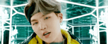a close up of a man wearing a headband and a yellow jacket