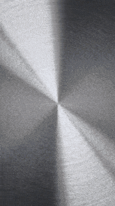 a close up of a stainless steel circular texture
