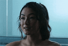 a naked woman is taking a bath in a bathtub .