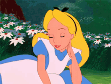 alice from alice in wonderland is sitting in a field of daisies with her eyes closed
