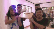 a group of men are posing for a picture while holding a plaque that says j on it .