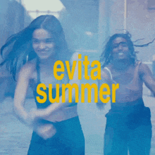 two women dancing in front of a sign that says " evitar summer "