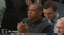 jay z is sitting in the stands watching a basketball game on nba tv