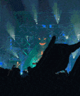 a crowd of people at a concert with a giant monster in the background