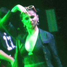 a woman in a black top with the number 11 on it is dancing