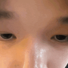 a close up of a person 's face with a few drops of water on it