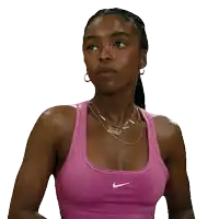 a woman wearing a pink nike sports bra looks down