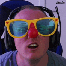 a man wearing a pair of sunglasses with a red nose and a star on them