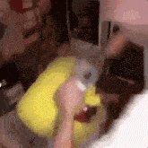 a blurry picture of a person holding a bottle in their hand