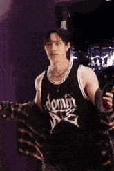 a young man wearing a black jersey that says domin dtg on it