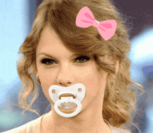 a woman with a pacifier in her mouth has a pink bow on her hair