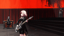 a girl playing a guitar in a dark room