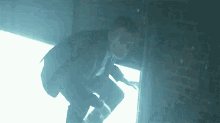 a man in a suit and tie is climbing up a wall