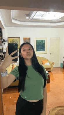 a woman taking a picture of herself in a living room
