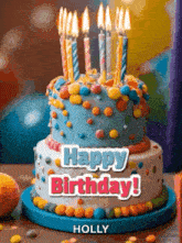 a birthday cake with candles on it and the words happy birthday holly