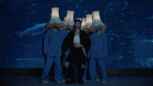 a woman is surrounded by lampshades on her head