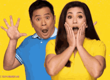 a man in a blue shirt and a woman in a yellow shirt are standing next to each other