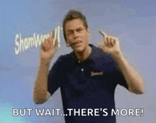 a man wearing a headset is making a sign that says `` but wait ... there 's more ! ''