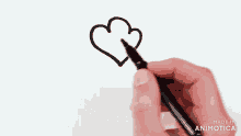 a person is drawing a heart with a marker and the words made in animotica are on the bottom
