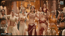 a group of women are dancing in front of a banner that says telugu