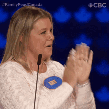 a woman wearing a name tag that says erin applauds