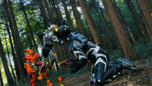 a man in a black and white suit is kneeling in a forest