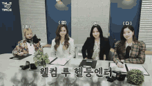 a group of girls are sitting at a table with their names written on them