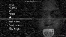 a black and white image of a baby with a pacifier in front of a screen that says five nights at abd 's